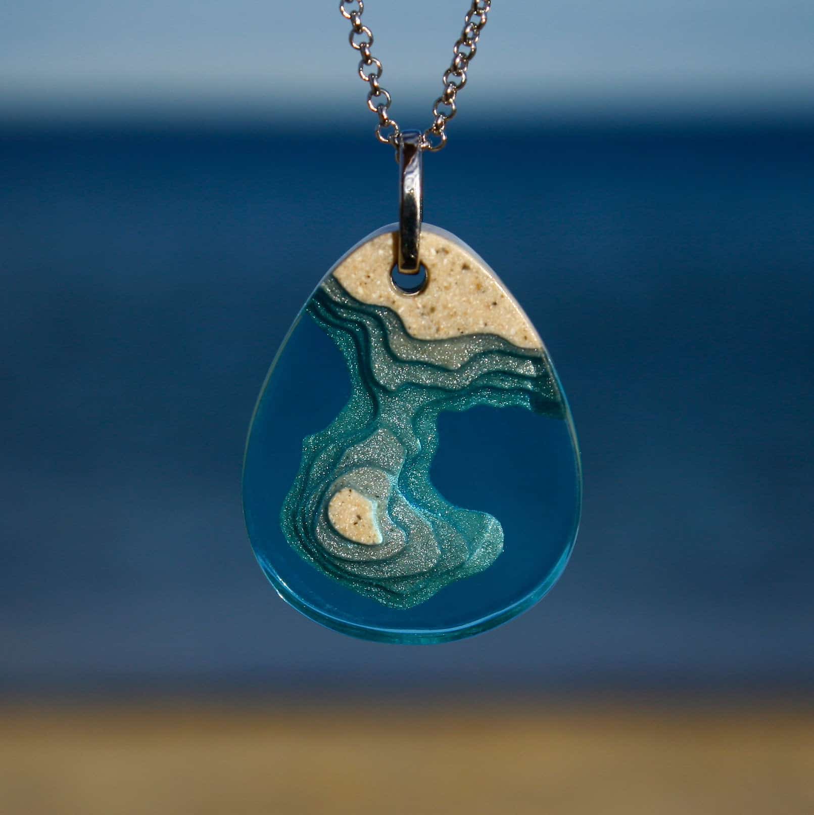 The Peninsula - handmade from beach sand and aqua blue resin on chain